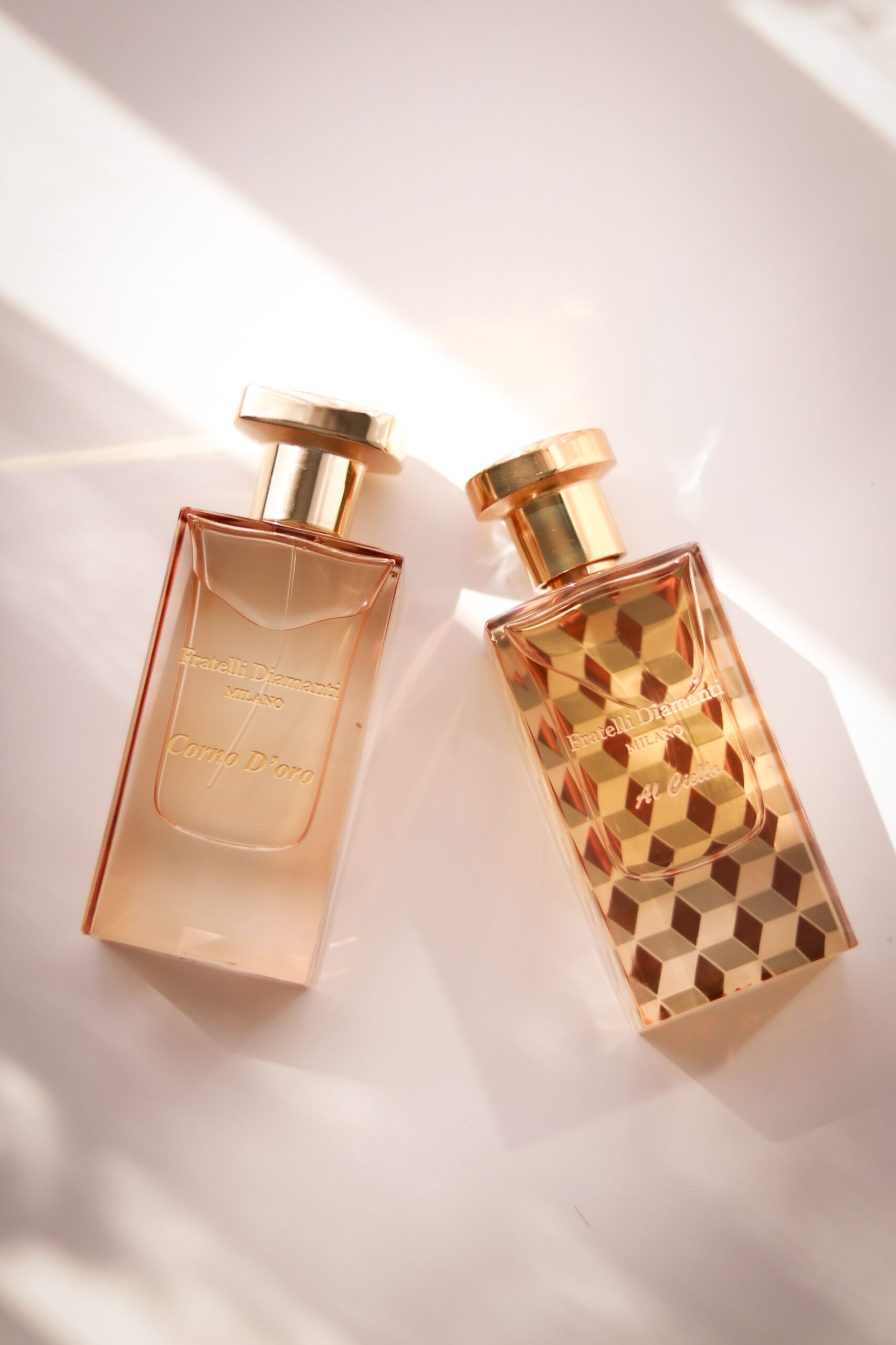 pexels photo 13875783 13875783 Two elegant perfume bottles with geometric designs in a bright setting.